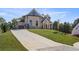 Wide driveway that leads to a beautiful two-story home with neutral paint and a dark grey roof at 1525 Tapestry Rdg, Lawrenceville, GA 30045
