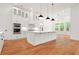 Kitchen with stainless steel appliances, white cabinets, and a large center island at 1525 Tapestry Rdg, Lawrenceville, GA 30045