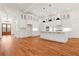 Bright, open kitchen with hardwood floors, a large island, and modern, all-white cabinetry at 1525 Tapestry Rdg, Lawrenceville, GA 30045