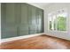 Comfortable room with custom wall paneling and hardwood floors at 1525 Tapestry Rdg, Lawrenceville, GA 30045