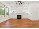 A spacious living room with hardwood floors, fireplace, and backyard views at 1525 Tapestry Rdg, Lawrenceville, GA 30045