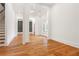 Bright living room featuring hardwood floors, white trim, and large doorways at 1525 Tapestry Rdg, Lawrenceville, GA 30045