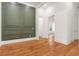 Stylish living room showcasing green accent wall, hardwood floors, and white trim at 1525 Tapestry Rdg, Lawrenceville, GA 30045