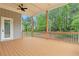Spacious porch with wood floors, ceiling fan, black iron railings, and views of the yard and trees at 1525 Tapestry Rdg, Lawrenceville, GA 30045