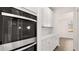 Double oven with stainless steel appliances and white cabinetry at 1798 Lacebark Elm Way, Lawrenceville, GA 30045