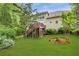 A spacious backyard with a wooden deck and stairs cascading to the lush green lawn at 10540 Waters Ridge Dr, Alpharetta, GA 30022
