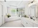 Bright bathroom with a garden tub, separate shower, and a vanity with plenty of storage space at 10540 Waters Ridge Dr, Alpharetta, GA 30022