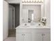 Bathroom featuring double sinks, a large mirror, a white vanity, and natural light at 10540 Waters Ridge Dr, Alpharetta, GA 30022