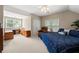 Spacious bedroom with a king bed, a ceiling fan, ample natural light, and neutral decor at 10540 Waters Ridge Dr, Alpharetta, GA 30022