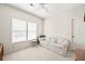 Neutral bedroom with a couch, a side table, built-in storage, and large windows at 10540 Waters Ridge Dr, Alpharetta, GA 30022