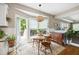 Sunlit dining area with a pendant light, natural accents, and a door leading to the deck at 10540 Waters Ridge Dr, Alpharetta, GA 30022