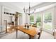 Sunlit dining room featuring large windows, a modern chandelier, and an open view to the foyer at 10540 Waters Ridge Dr, Alpharetta, GA 30022