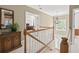 Foyer featuring a staircase, wood accents, a chandelier, and a view to the main bedroom at 10540 Waters Ridge Dr, Alpharetta, GA 30022