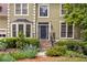 Inviting entryway featuring a stone staircase, neatly trimmed bushes, and a freshly painted dark front door at 10540 Waters Ridge Dr, Alpharetta, GA 30022