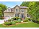 Charming two-story home with a well-manicured lawn, stone stairs, and beautifully landscaped front yard at 10540 Waters Ridge Dr, Alpharetta, GA 30022
