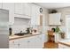 Kitchen with white cabinets, stainless steel appliances, gas cooktop, and a cozy desk area at 10540 Waters Ridge Dr, Alpharetta, GA 30022