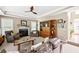 Spacious living room featuring a fireplace, tray ceilings, large windows and comfortable seating at 10540 Waters Ridge Dr, Alpharetta, GA 30022