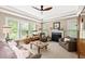 Inviting living room featuring a fireplace, tray ceiling, plenty of light, and comfortable furnishings at 10540 Waters Ridge Dr, Alpharetta, GA 30022
