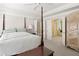 Spacious main bedroom featuring a four-poster bed and access to an en-suite bathroom at 10540 Waters Ridge Dr, Alpharetta, GA 30022