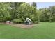 Community playground with slide, climbing area, and playhouse situated on a lush green lawn at 10540 Waters Ridge Dr, Alpharetta, GA 30022