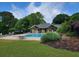 Community pool and clubhouse surrounded by lush greenery, offering a resort-like experience at 10540 Waters Ridge Dr, Alpharetta, GA 30022