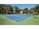 Well-maintained blue and green community tennis court for recreational enjoyment and fitness at 10540 Waters Ridge Dr, Alpharetta, GA 30022