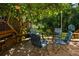 Charming backyard deck with a seating area under the shade of a mature tree, perfect for outdoor gatherings at 164 Ridley Cir, Decatur, GA 30030