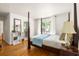 Bedroom with hardwood floors, a canopy bed, and ensuite bathroom access at 164 Ridley Cir, Decatur, GA 30030