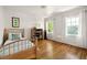 Bright bedroom features hardwood floors, two windows, and light wood furniture at 164 Ridley Cir, Decatur, GA 30030
