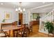 Open dining room flowing into the kitchen featuring hardwood floors and a view of the staircase at 164 Ridley Cir, Decatur, GA 30030
