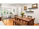 Charming dining room featuring a wood table, bench, and hardwood floors with access to the sunroom at 164 Ridley Cir, Decatur, GA 30030