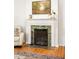 Living room fireplace with decorative tile surround and wood mantle adds warmth and charm to the home's interior at 164 Ridley Cir, Decatur, GA 30030