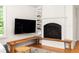 Living room featuring fireplace with wooden seating, and a wall-mounted television at 164 Ridley Cir, Decatur, GA 30030