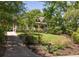 Beautiful house with mature trees, a manicured lawn and driveway leading to the residence at 164 Ridley Cir, Decatur, GA 30030