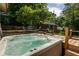 Serene backyard featuring a hot tub with scenic views of mature trees and landscaping at 164 Ridley Cir, Decatur, GA 30030