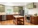 Spacious kitchen with stainless steel appliances, a central island, and custom green cabinetry at 164 Ridley Cir, Decatur, GA 30030