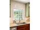 Bright kitchen with a stainless steel sink, marble countertops, and charming green cabinets at 164 Ridley Cir, Decatur, GA 30030