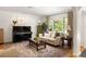 Bright living room featuring a large window, hardwood floors, and a comfortable seating arrangement at 164 Ridley Cir, Decatur, GA 30030