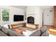 Living room with a fireplace, built-in shelving, hardwood floors, and modern furniture at 164 Ridley Cir, Decatur, GA 30030