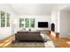 Bright living room with a cozy fireplace, hardwood floors, and large windows offering natural light at 164 Ridley Cir, Decatur, GA 30030