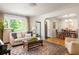 Bright living room with hardwood floors, a comfortable sofa, and a view into the dining area at 164 Ridley Cir, Decatur, GA 30030