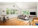 Sunlit living room features large windows, hardwood floors, and stylish modern furniture at 164 Ridley Cir, Decatur, GA 30030
