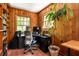 Wood paneled home office featuring a built in bookshelf and natural light from two windows at 164 Ridley Cir, Decatur, GA 30030