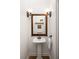 Elegant powder room featuring pedestal sink, decorative mirror, and sconce lighting for a touch of sophistication at 164 Ridley Cir, Decatur, GA 30030