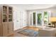 Bright sunroom with hardwood floors, white armchairs, french doors, and neutral built in cabinets at 164 Ridley Cir, Decatur, GA 30030