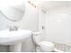 Bright bathroom featuring a pedestal sink, modern fixtures, and a tiled walk-in shower at 2607 Jefferson Ter, Atlanta, GA 30344