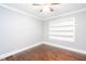 The bedroom features a ceiling fan, hardwood floors, and built-in shelving at 2607 Jefferson Ter, Atlanta, GA 30344