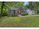 Charming brick bungalow with red door, landscaped yard, and inviting curb appeal at 2607 Jefferson Ter, Atlanta, GA 30344
