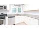 A well-lit kitchen with white cabinets, granite counters, and stainless steel appliances at 2607 Jefferson Ter, Atlanta, GA 30344