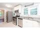 Bright kitchen boasts stainless steel appliances, granite countertops, and modern tile flooring at 2607 Jefferson Ter, Atlanta, GA 30344